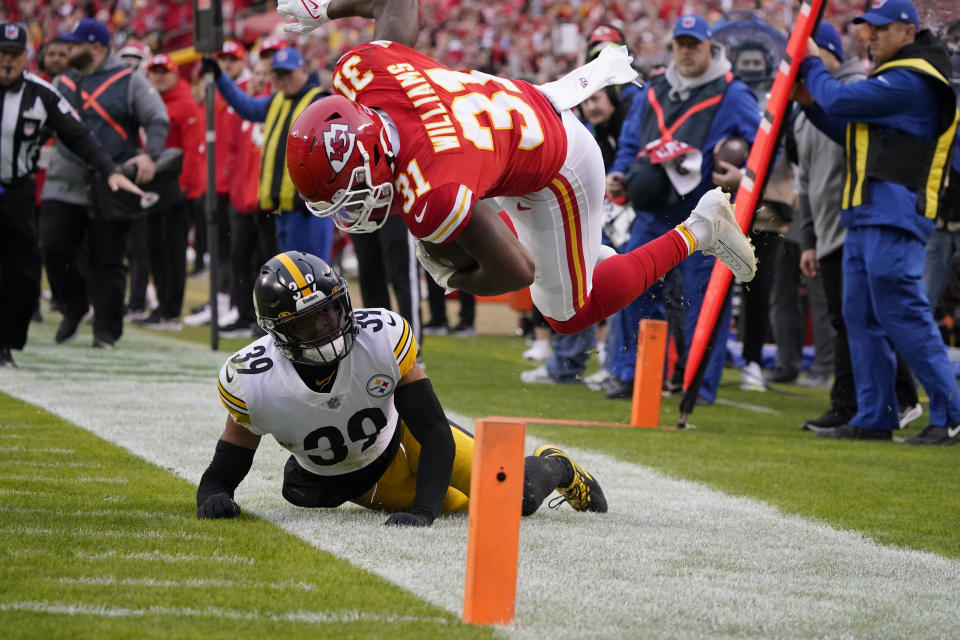 Kansas City Chiefs running back Darrel Williams (31) is knocked out of bounds by Pittsburgh Steelers free safety Minkah Fitzpatrick (39) during the first half of an NFL football game Sunday, Dec. 26, 2021, in Kansas City, Mo. (AP Photo/Ed Zurga)