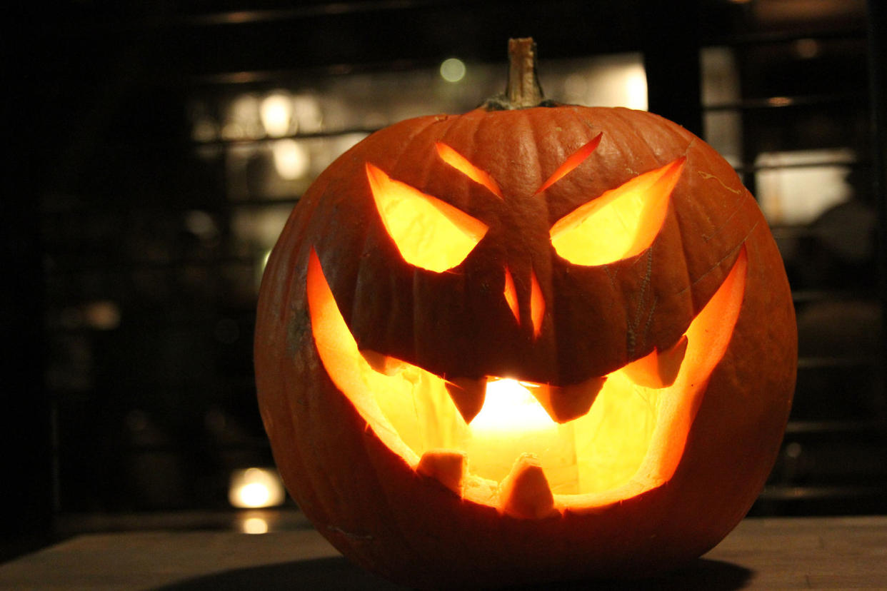 Illuminated Jack-O-Lantern On Table (Ashley Sandberg / EyeEm / Getty Images stock)