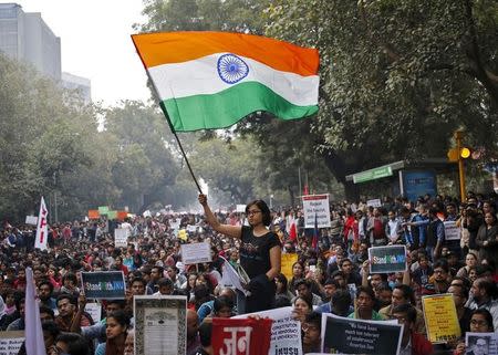 A demonstrator waves Indian national flag as she takes part in a protest demanding the release of Kanhaiya Kumar, a Jawaharlal Nehru University (JNU) student union leader accused of sedition, in New Delhi, India, February 18, 2016. REUTERS/Anindito Mukherjee