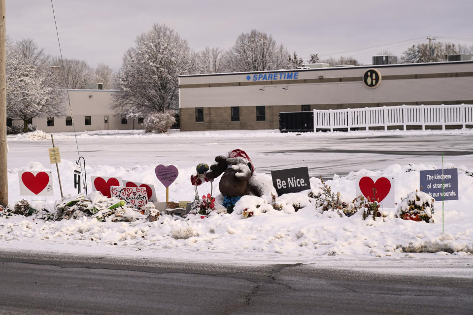 Snow accumulates outside a bowling alley at a makeshift memorial for the victims of last month's mass shooting in Lewiston, Maine, Tuesday, Dec. 5, 2023. With winter approaching, officials began removing memorials to the 18 people killed. (AP Photo/Robert F. Bukaty)