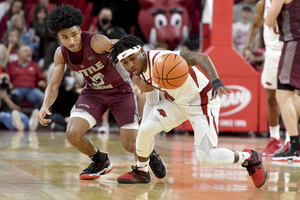 Arkansas guard Chris Lykes (11) steals the ball from Arkansas-Little Rock guard D.J. Smith (13) during the first half of an NCAA college basketball game Saturday, Dec. 4, 2021, in Fayetteville, Ark. (AP Photo/Michael Woods)