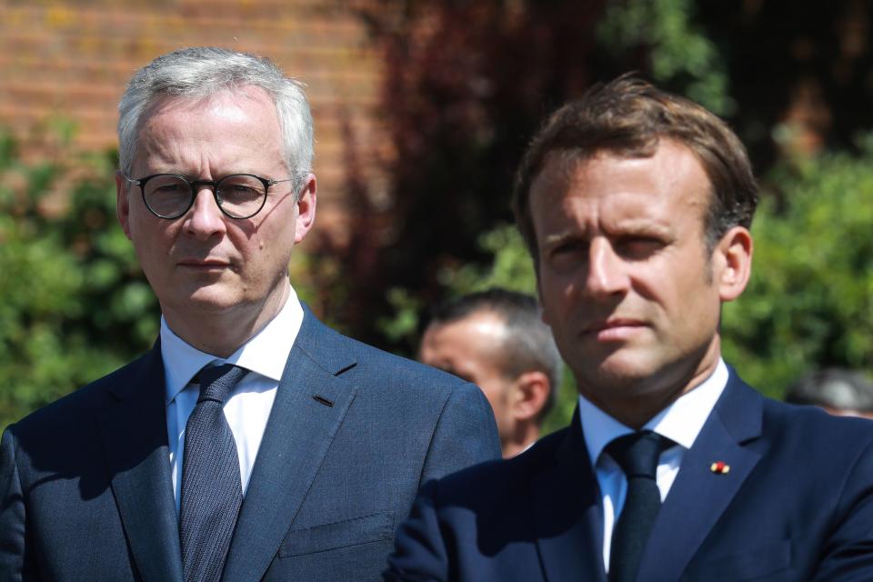 French President Emmanuel Macron (R) and French Economy and Finance Minister Bruno Le Maire (L) visit a factory of manufacturer Valeo in Etaples, near Le Touquet, northern France on May 26, 2020 as part of the launch of a plan to rescue the French car industry. (Photo by Ludovic MARIN / AFP) (Photo by LUDOVIC MARIN/AFP via Getty Images)