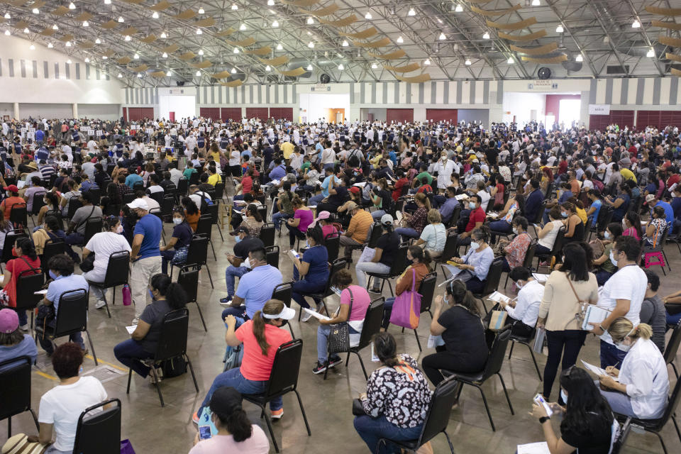 FILE - Education workers wait for their jab of the single-dose CanSino COVID-19 vaccine during a vaccination drive at the World Trade Center in Boca del Rio, Veracruz state, Mexico, April 20, 2021. On Monday, the U.S. will implement a new air travel policy to allow in foreign citizens who have completed a course of a vaccine approved by the Food and Drug Administration or the World Health Organization. That leaves people in Mexico, Hungary, Russia and elsewhere who received the non-approved Russian Sputnik V vaccine or the China-produced CanSino vaccine ineligible to board U.S.-bound flights. (AP Photo/Felix Marquez, File)