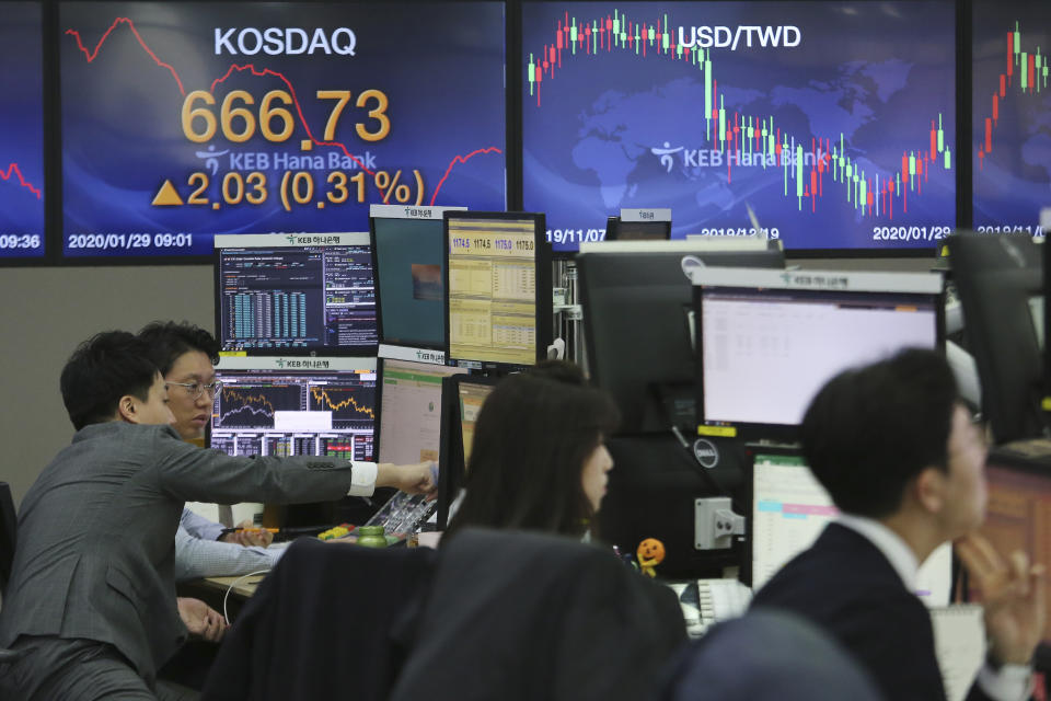 Currency traders watch monitors at the foreign exchange dealing room of the KEB Hana Bank headquarters in Seoul, South Korea, Wednesday, Jan. 29, 2020. Shares are mostly higher in Asia after a rebound on Wall Street that reversed most losses from a sell-off the day before. (AP Photo/Ahn Young-joon)