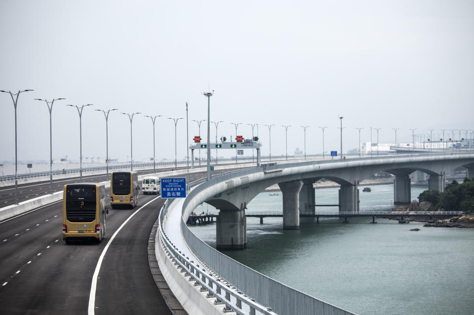 <p>Shuttle buses travel along the Hong Kong Link Road section of the Hong Kong-Zhuhai-Macau Bridge during a media tour. (Getty) </p>