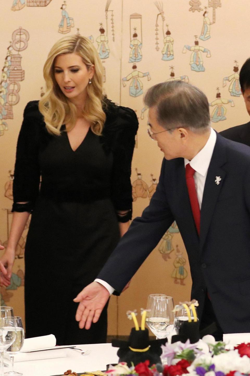 Moon Jae-In helps Ivanka Trump get seated at their dinner at the Presidential Blue House in Seoul (REUTERS)