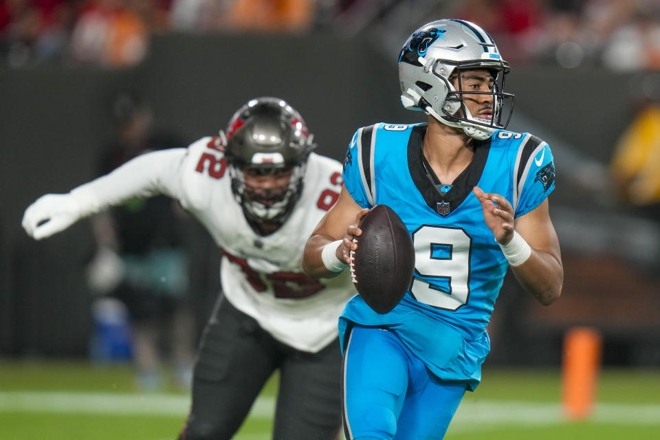 Carolina Panthers quarterback Bryce Young is chased by Tampa Bay Buccaneers defensive end William Gholston during the second half of an NFL football game Sunday, Dec. 3, 2023, in Tampa, Fla. (AP Photo/Chris O'Meara)