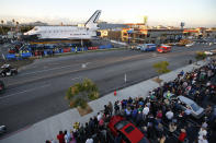 Spectators gather to watch the space shuttle Endeavour in Los Angeles, Friday, Oct. 12, 2012. Endeavour's 12-mile road trip kicked off shortly before midnight Thursday as it moved from its Los Angeles International Airport hangar en route to the California Science Center, its ultimate destination, said Benjamin Scheier of the center. (AP Photo/Jae C. Hong)