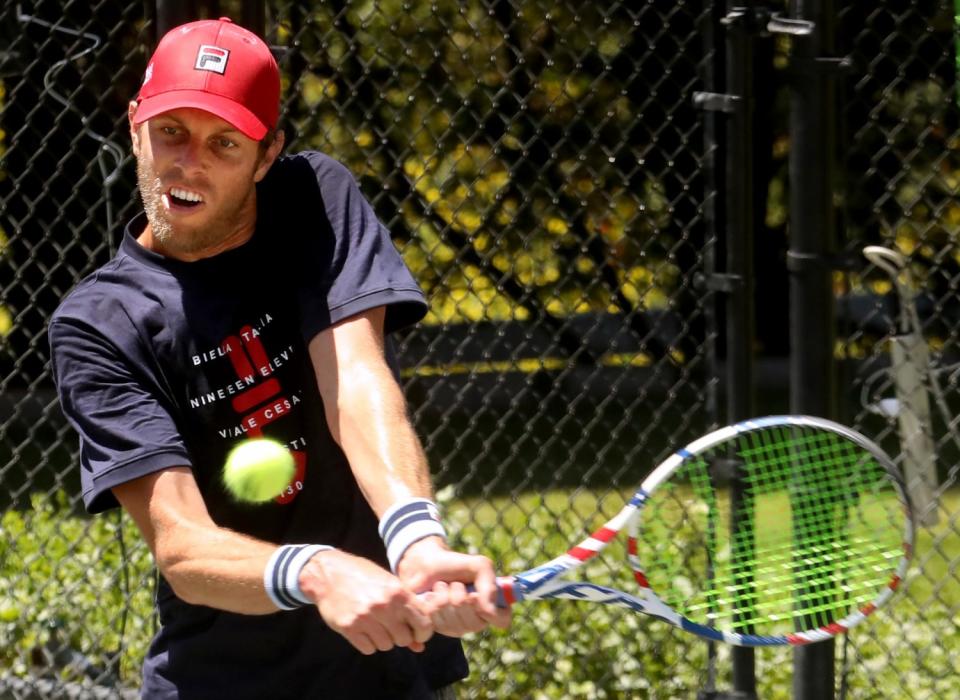 Sam Querrey returns a shot from Brandon Holt during the final round.