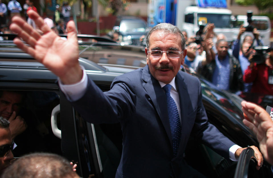 Danilo Medina, presidential candidate of the ruling Dominican Liberation Party, cheers to the crowd while leaving a polling station after casting his ballot during the presidential election in Santo Domingo, Dominican Republic, Sunday May 20, 2012. (AP Photo/Ricardo Arduengo)