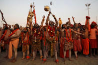 Naga Sadhus or Hindu holy men arrive to take a dip during the first "Shahi Snan" (grand bath) during "Kumbh Mela" or the Pitcher Festival, in Prayagraj, previously known as Allahabad, India, January 15, 2019. REUTERS/Danish Siddiqui