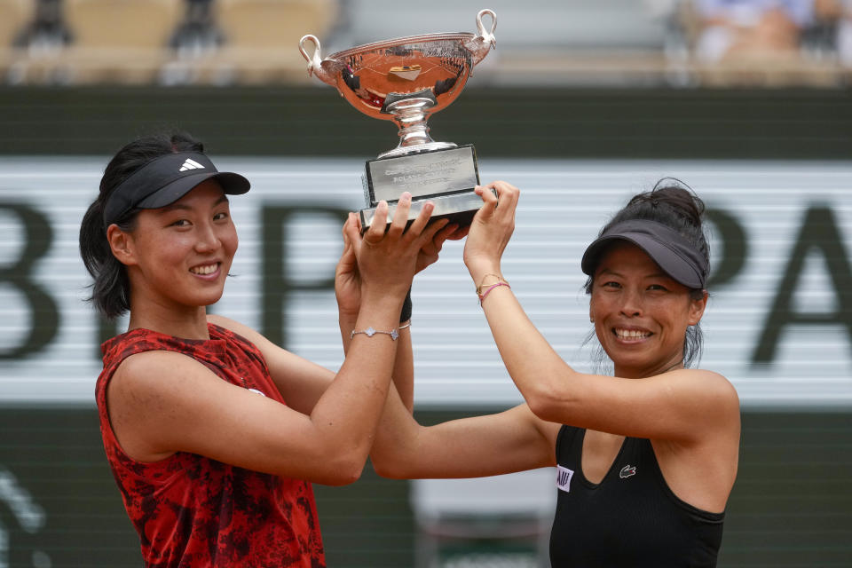 China's Wang Xinyu, left, and Hsieh Su-Wei of Taiwan lift the trophy as they celebrate winning the women's doubles final match of the French Open tennis tournament against Canada's Leylah Fernandez and Taylor Townsend of the U.S. at the Roland Garros stadium in Paris, Sunday, June 11, 2023. (AP Photo/Thibault Camus)