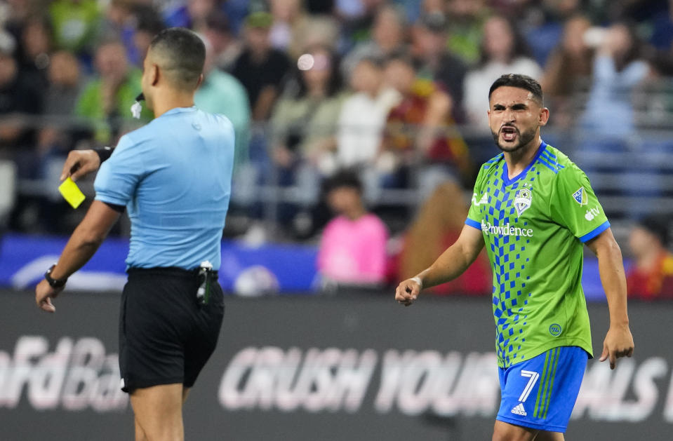 Seattle Sounders midfielder Cristian Roldan reacts to receiving a yellow card from referee Nima Saghafi during the first half of the team's MLS soccer match against the Vancouver Whitecaps, Saturday, Oct. 7, 2023, in Seattle. (AP Photo/Lindsey Wasson)