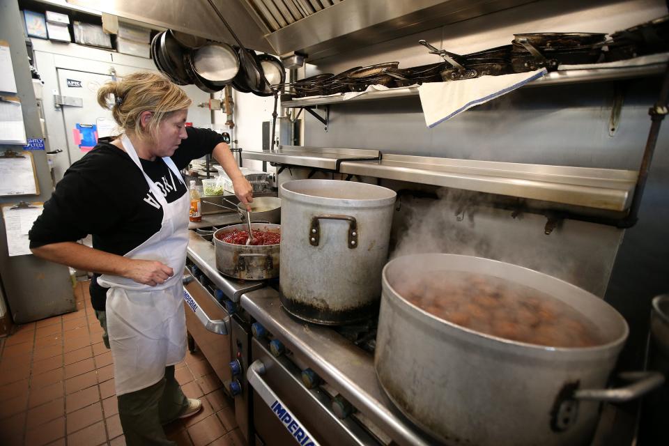 Marilyn Schlossbach, owner of Langosta Lounge in Asbury Park, prepares cranberry sauce during the restaurant's annual Christmas Community Dinner in 2018.