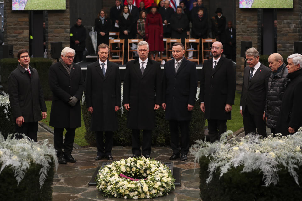 U.S. Secretary of Defence Mark Esper, second left, German President Frank-Walter Steinmeier, third left, Luxembourg's Grand Duke Henri, fourth left, Belgium's King Philippe, fifth left, Poland's President Andrej Duda, sixth left, European Council President Charles Michel, fourth right, and other authorities stand up during a minute of silence during a ceremony to commemorate the 75th anniversary of the Battle of the Bulge at the Mardasson Memorial in Bastogne, Belgium on Monday, Dec. 16, 2019. The Battle of the Bulge, also called Battle of the Ardennes, took place between Dec. 1944 and Jan. 1945 and was the last major German offensive on the Western Front during World War II. (AP Photo/Francisco Seco)