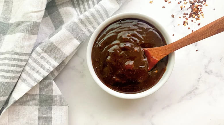 Barbecue sauce in pot with spoon