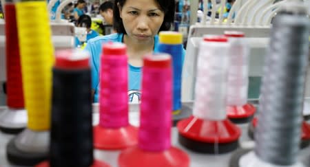 A woman works at Maxport garment company in Hanoi