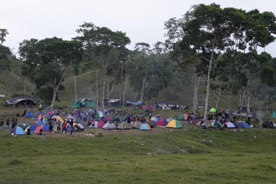 Migrants camp on a field in Acandi, Colombia, Tuesday, Sept. 14, 2021. The migrants, following a well-beaten, multi-nation journey towards the U.S., will continue their journey through the jungle known as the Darien Gap. (AP Photo/Fernando Vergara)