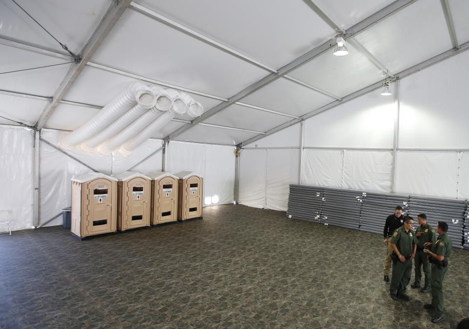 U.S. Border Patrol unveils the new 500-person tent facility during a media tour meant to process detained immigrant children and families who cross the U.S. border Friday, June 28, 2019, in Yuma, Ariz. The Border Patrol says it will start placing families there on Friday night. (AP Photo/Ross D. Franklin)