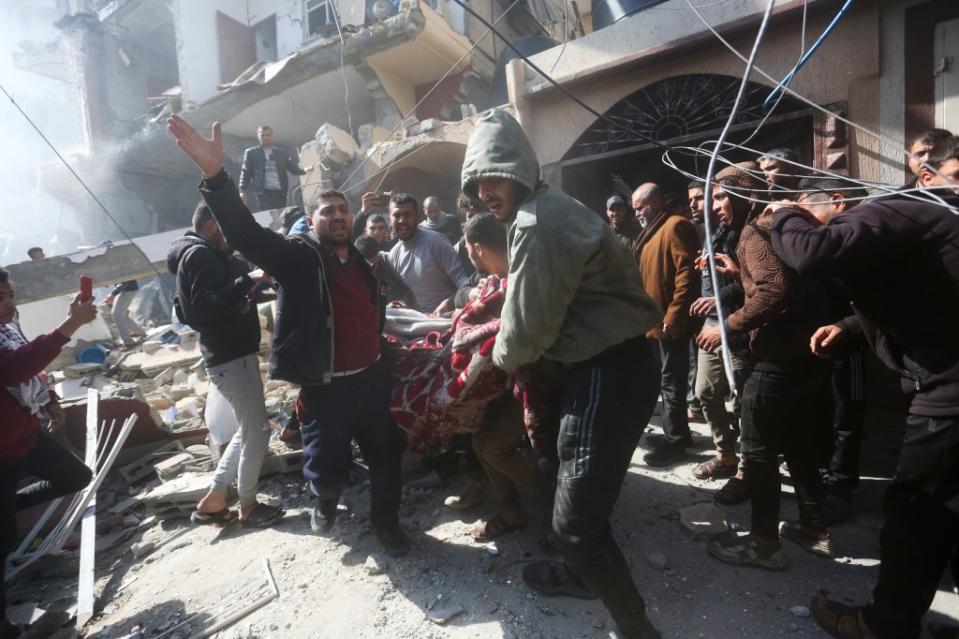 Palestinians rescue survivors after an Israeli strike on Shaheen family house in Rafah, Gaza Strip. AP