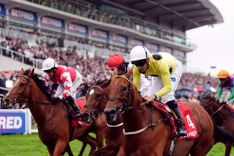 Bolster, ridden by jockey Pierre-Louis Jamin (yellow, no.4), on the way to winning the Betfred Nifty 50 Handicap on day one of the Betfred Derby Festival at Epsom Downs Racecourse on Friday, May 31 2024