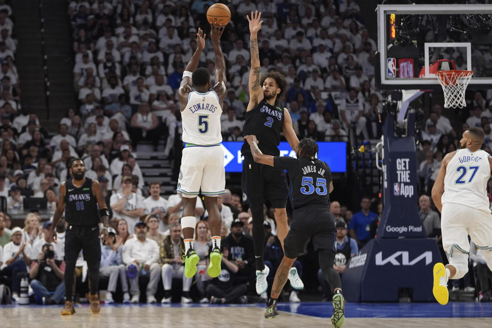 Minnesota Timberwolves guard Anthony Edwards (5) shoots over Dallas Mavericks center Dereck Lively II (2) during the first half of Game 2 of the NBA basketball Western Conference finals, Friday, May 24, 2024, in Minneapolis. (AP Photo/Abbie Parr)