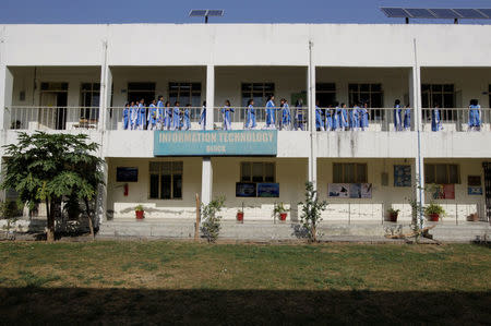 Students walk to their classroom at the Islamabad College for girls in Islamabad, Pakistan, October 13, 2017. REUTERS/Caren Firouz