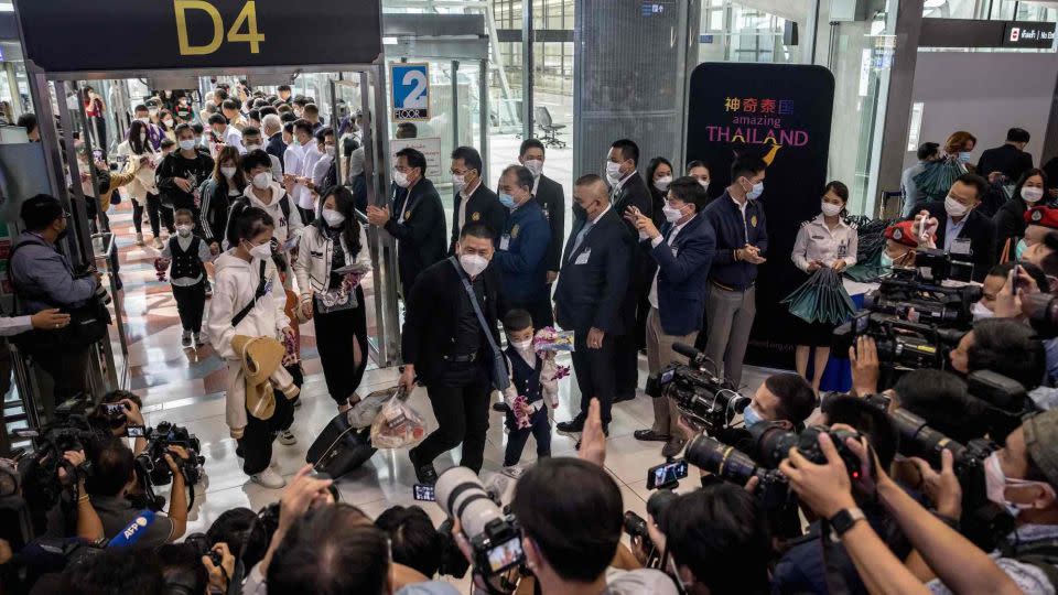 Chinese travellers are greeted by members of the Thai media upon arrival at Bangkok's Suvarnabhumi Airport. - Jack Taylor/AFP/Getty Images