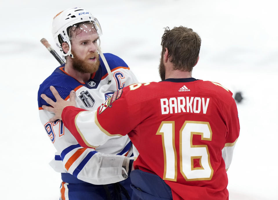 Edmonton Oilers forward Connor McDavid (97) congratulates Florida Panthers forward Aleksander Barkov (16) after Florida won Game 7 of the NHL hockey Stanley Cup Final in Sunrise, Fla., Monday, June 24, 2024. (Nathan Denette/The Canadian Press via AP)