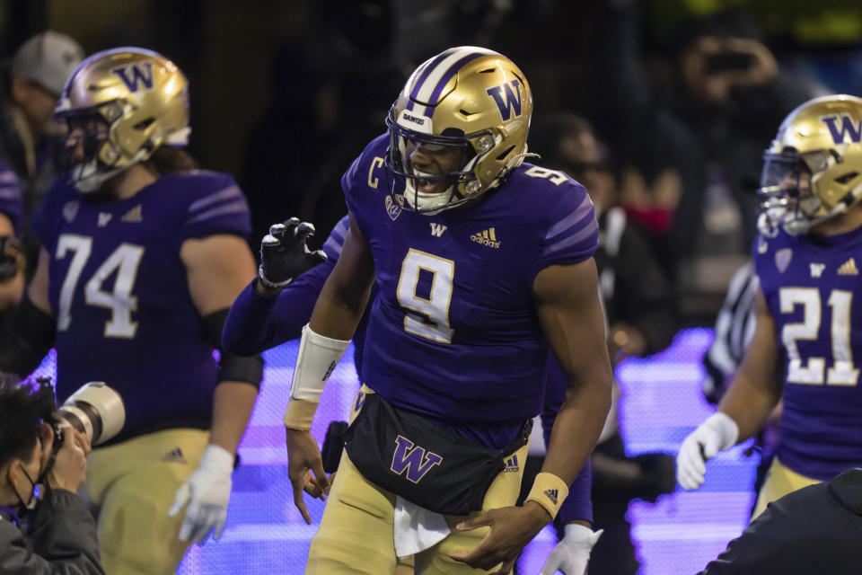 Washington quarterback Michael Penix Jr. celebrates a touchdown during the first half of the team's NCAA college football game against Colorado, Saturday, Nov. 19, 2022, in Seattle. (AP Photo/Stephen Brashear)