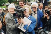 FILE - Britain's Prime Minister and Conservative Party leader, Margaret Thatcher tries her hand with a television camera, during a visit to her constituency of Finchley, London, on General Election day in the United Kingdom, June 11, 1987. Caulkin, a retired Associated Press photographer has died. He was 77 and suffered from cancer. Known for being in the right place at the right time with the right lens, the London-based Caulkin covered everything from the conflict in Northern Ireland to the Rolling Stones and Britain’s royal family during a career that spanned four decades. (AP Photo/Dave Caulkin, File)