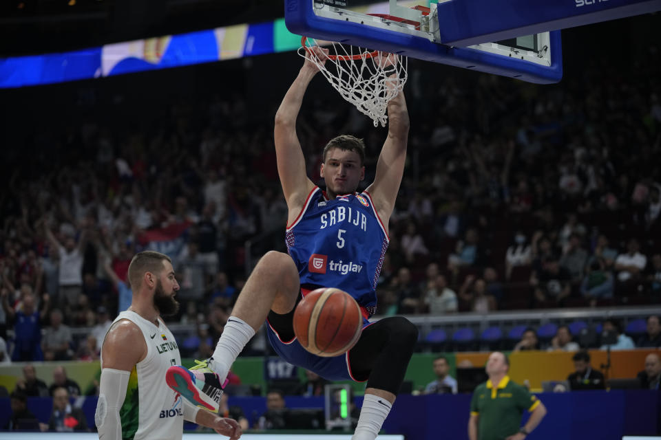 Serbia forward Nikola Jovic (5) dunks the ball during the Basketball World Cup quarterfinal game between Lithuania and Serbia at the Mall of Asia Arena in Manila, Philippines, Tuesday, Sept. 5, 2023. (AP Photo/Aaron Favila)