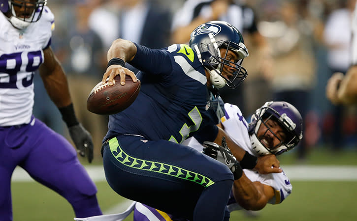 Seattle Seahawks quarterback Russell Wilson is sacked by Minnesota Vikings strong safety Andrew Sendejo during the second quarter at CenturyLink Field.