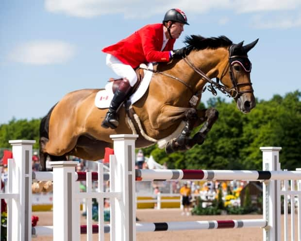 Saint-Jean, Que., native Mario Deslauriers went double clear with Bardolina 2 horse to capture the ATCO Queen Elizabeth II Cup at Spruce Meadows in Calgary on Saturday. (Cealy Tetley/@Equestrian_Can/Twitter - image credit)