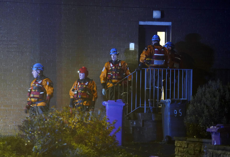 Emergency services work on River Street in Stonehaven, Scotland, knocking on doors and asking residents to evacuate due to flood warnings, Thursday, Oct. 19, 2023. Hundreds of people are being evacuated from their homes and schools have closed in parts of Scotland, as much of northern Europe braces for stormy weather, heavy rain and gale-force winds from the east. The U.K.’s weather forecaster, the Met Office, issued a rare red alert, the highest level of weather warning, for parts of Scotland. (Andrew Milligan/PA via AP)