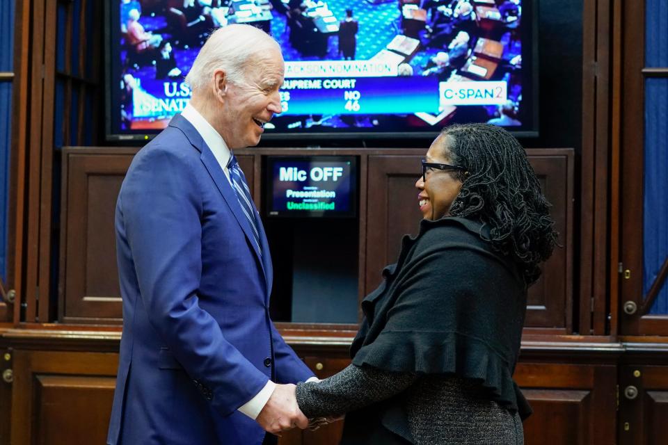 President Joe Biden holds hands with Supreme Court nominee Judge Ketanji Brown Jackson as they watch the Senate vote on her confirmation from the Roosevelt Room of the White House in Washington, Thursday, April 7, 2022.