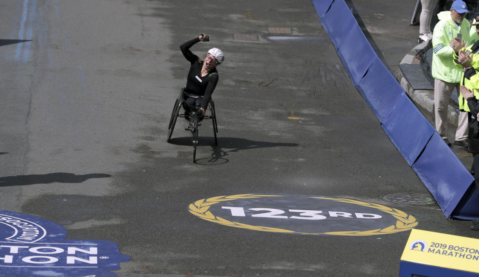 Manuela Schar, of Switzerland, celebrates as she heads to the finish line to win the women's handcycle division of the 123rd Boston Marathon on Monday, April 15, 2019, in Boston. (AP Photo/Charles Krupa)