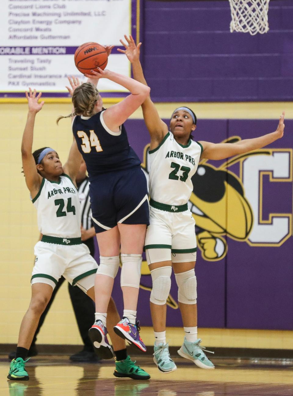 Ypsilanti Arbor Prep's Stacy Utomi, left, and Stephanie Utomi defend Brooklyn Columbia Central's Zoie Bamm during the second half of Arbor Prep's 50-42 win in the MHSAA Division 3 regional semifinal at Concord High School on Tuesday, March 7, 2023.