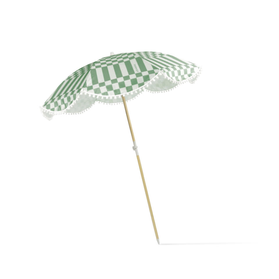 This image provided by Minnidip shows an item from the Hotel Minnidip collection designed by Emily Vaca. There's the jaunty green and white Checker Cabana Stripe umbrella in UV-protecting polyester. It can be toted beachside or poolside, and popped into the ground or a base stand. (Minnidip via AP)