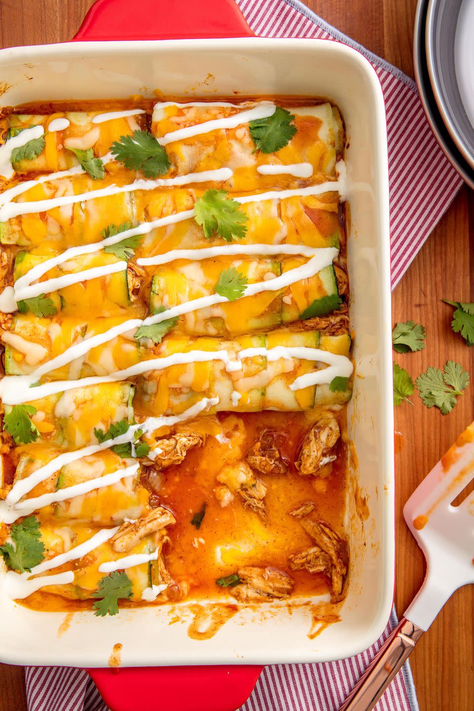<p>We created a recipe that will satisfy your craving for cheesy, saucy <a href="https://www.delish.com/cooking/recipe-ideas/a49105/cheesy-chicken-enchiladas-recipe/" rel="nofollow noopener" target="_blank" data-ylk="slk:chicken enchiladas;elm:context_link;itc:0;sec:content-canvas" class="link ">chicken enchiladas</a> while still keeping things light. Instead of using flour tortillas, we use tender, thin slices of zucchini to wrap up the chicken. Smothered with melted Monterey Jack and spicy <a href="https://www.delish.com/cooking/recipe-ideas/a25837054/enchilada-sauce-recipe/" rel="nofollow noopener" target="_blank" data-ylk="slk:enchilada sauce;elm:context_link;itc:0;sec:content-canvas" class="link ">enchilada sauce</a>, you'll barely notice the difference!</p><p>Get the <strong><a href="https://www.delish.com/cooking/recipe-ideas/recipes/a51783/zucchini-enchiladas-recipe/" rel="nofollow noopener" target="_blank" data-ylk="slk:Zucchini Enchiladas recipe;elm:context_link;itc:0;sec:content-canvas" class="link ">Zucchini Enchiladas recipe</a></strong>.</p>