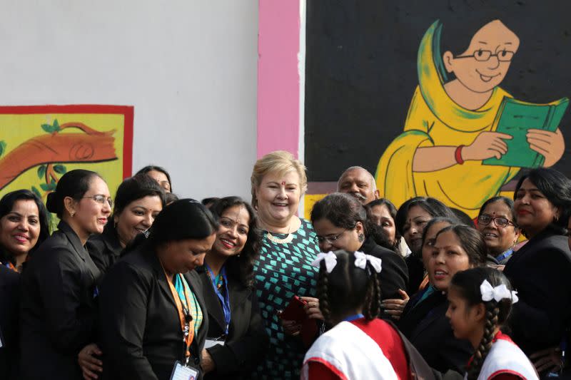 FILE PHOTO: Norway's Prime Minister Erna Solberg poses for a photograph with staff and students during her visit to a government-run school in Ghaziabad