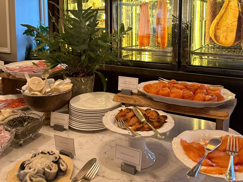 The charcuterie section of a buffet with various types of fish and meats