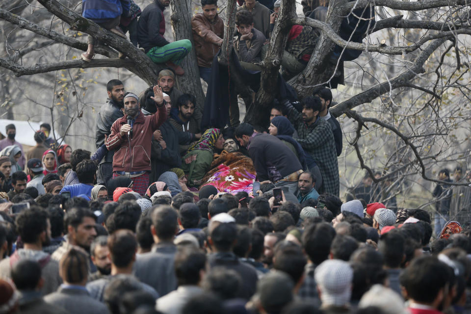 In this Nov. 20, 2018, photo, an unidentified Kashmiri Muslim kisses the body of rebel Bashrat Ahmad during his funeral at Shopian, south of Srinagar, Indian controlled Kashmir. Four rebels and an Indian army commando were killed in fighting in disputed Kashmir on Tuesday, triggering anti-India protests and clashes in the restive region. (AP Photo/Mukhtar Khan, File)