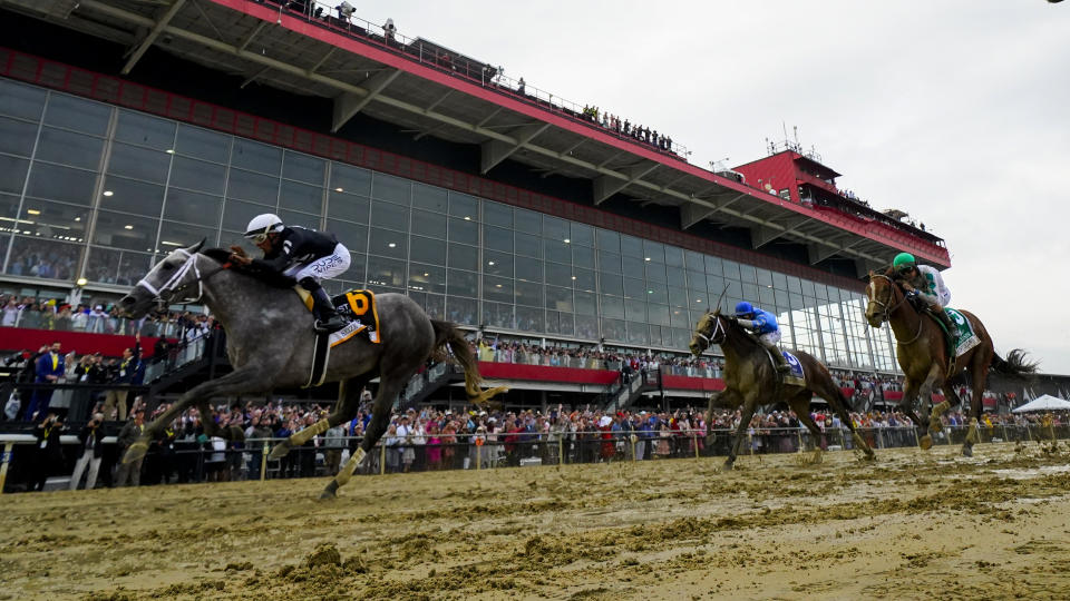 Jaime Torres, left, atop Seize The Grey, crosses the finish line in front of Flavien Prat, center, atop Catching Freedom, and Brian Hernandez, Jr., atop Mystik Dan, while winning the Preakness Stakes horse race at Pimlico Race Course, Saturday, May 18, 2024, in Baltimore. (AP Photo/Julio Cortez)