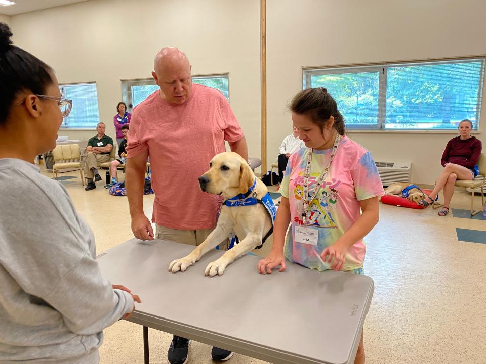 Jazmin Tinsley, 23, of Rehoboth Beach, training with her service dog, Bonus, whom she received from Canine Companions to help with her disabilities.