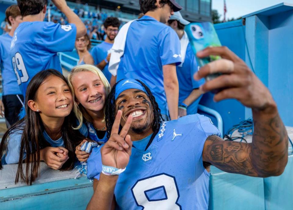 North Carolina’s Kobe Paysour (8) takes a selfie with fans following the Tar Heels’ 40-7 victory over Syracuse on Saturday, October 7, 2023 at Kenan Stadium in Chapel Hill, N.C.