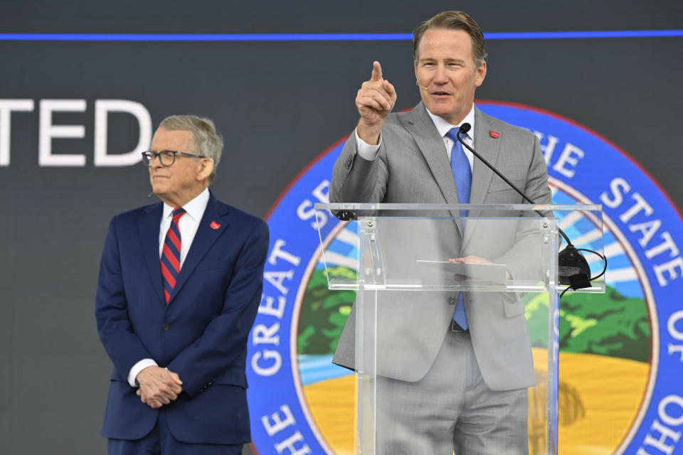 Ohio Lieutenant Governor Jon Husted, right, speaks beside Ohio Gov. Mike DeWine during a press conference, Thursday, June 2, 2022, in Avon Lake, Ohio. Ford announced it will add 6,200 factory jobs in Michigan, Missouri and Ohio as it prepares to build more electric vehicles and roll out two redesigned combustion-engine models. (AP Photo/David Richard)