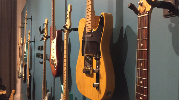 Guitars from Fender's American Professional Series line the walls of a gallery space in the meatpacking district of New York City Wednesday night. (Photo: Michael Walsh/Yahoo News)