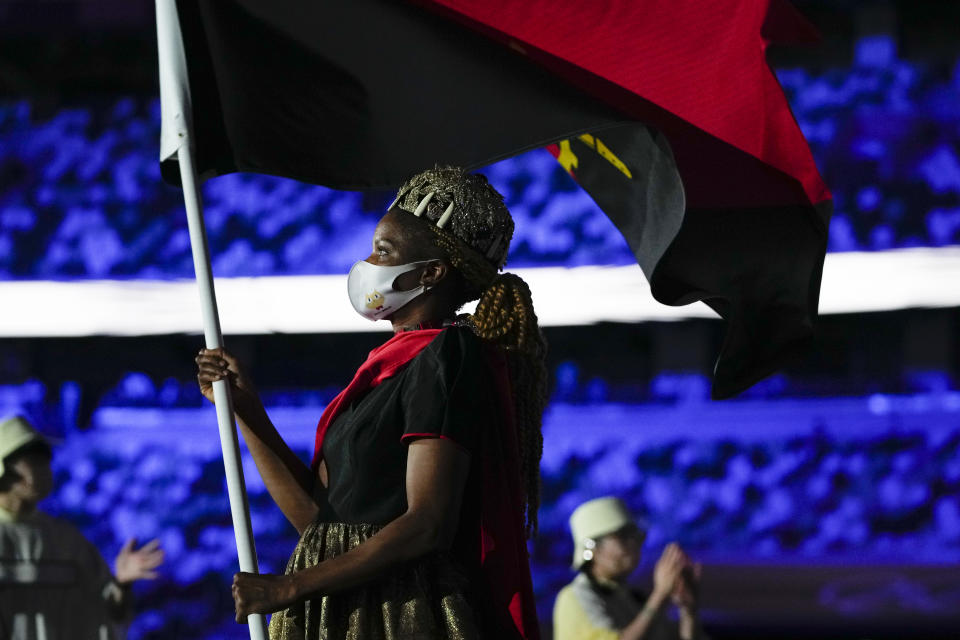 Natalia Santos of Angola, carry her country's flag during the opening ceremony in the Olympic Stadium at the 2020 Summer Olympics, Friday, July 23, 2021, in Tokyo, Japan. (AP Photo/Natacha Pisarenko)