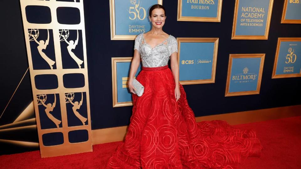 woman in red dress on red carpet